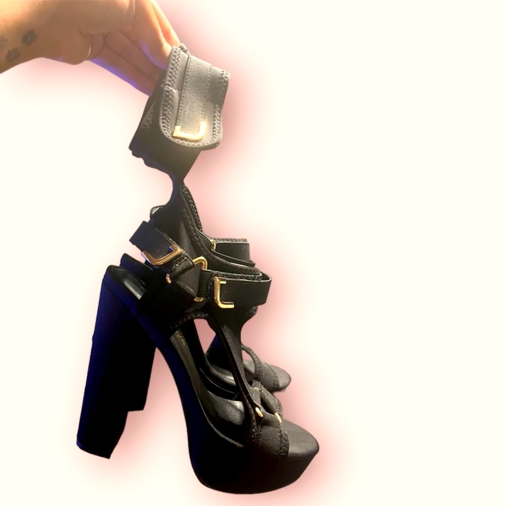 Black and gold small platform heels.
